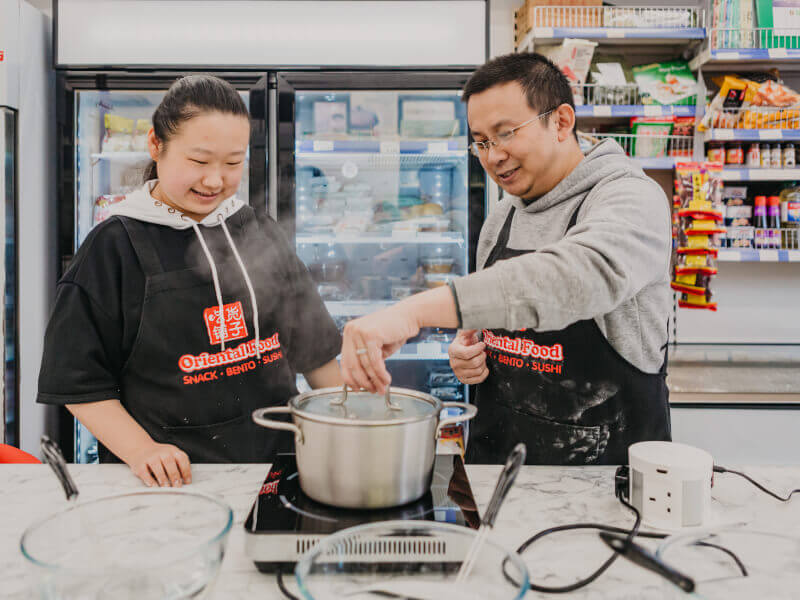 Two people making homemade tea at a tea tasting class in London